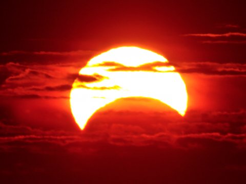 A partial solar eclipse, where the moon only blocks part of the sun. 