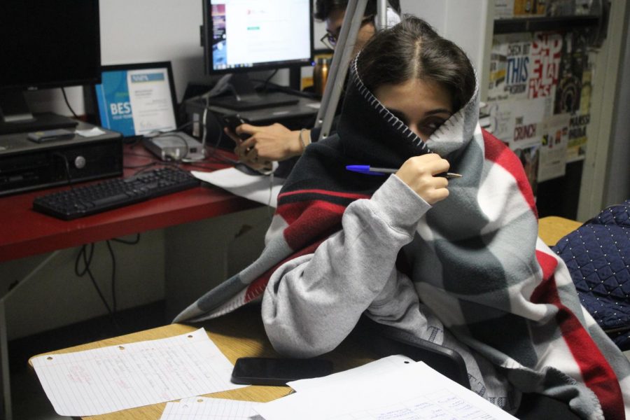 Due to cold temperatures in school, Senior Nicole Amsellem wraps up in a blanket to stay warm from the AC and cold weather. The temperature in North Miami was 44 degrees Fahrenheit on December 14, 2017.