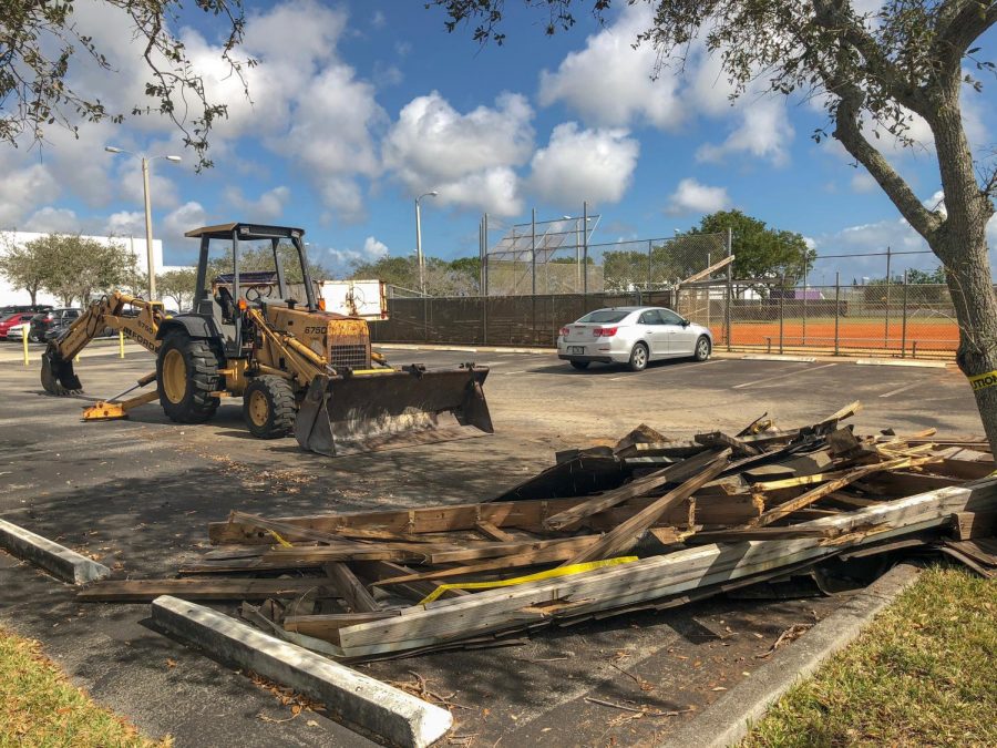 An+MDCPS+Maintenance+and+Operations+bulldozer+clears+the+student+parking+lot+of+the+dugouts+roof+wreckage.+The+debris+had+blown+away+during+Hurricane+Irma+in+Sept.+2017.