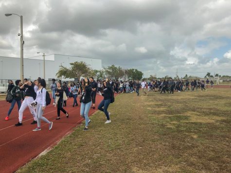 Students walk the track in support of gun control reform as a part of the walk-out movement, which aims to bolster support for gun control. More than two-hundred students circled the track starting at noon on Feb. 21.