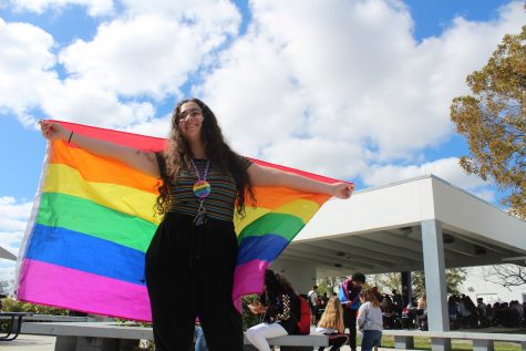 Student Keren Yehezkely holds a rainbow flag on Diversity Day to represent support for the LGBTQ+ community 