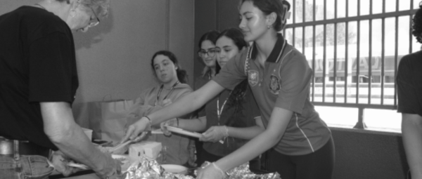 SCHOOL SPIRIT: Students serve paells and pastelitos at the Hispanic Heritage teacher luncheon on Oct. 6.