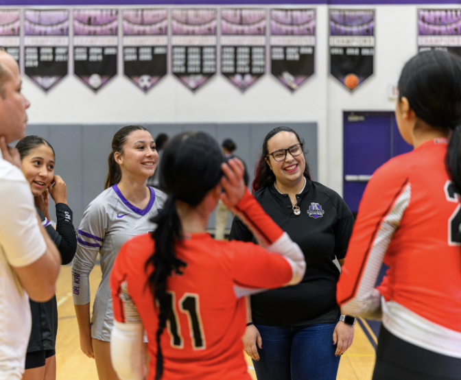 ALL SMILES: Head Varsity Volleyball Coach Jessika Lozada, smiling with the opposing team’s players.